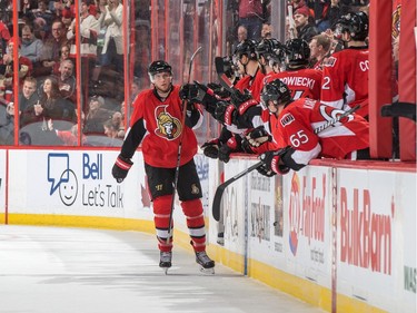 Bobby Ryan #6 of the Ottawa Senators celebrates his second period goal against the Buffalo Sabres with teammates at the players bench.