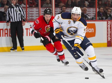 Evander Kane #9 of the Buffalo Sabres stickhandles the puck as he is chased by Mark Stone #61 of the Ottawa Senators.