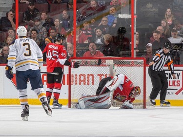 Referee Ghislain Hebert signals a goal by the Buffalo Sabres against Craig Anderson #41 as Chris Wideman #45 of the Ottawa Senators and Mark Pysyk #3 look on.