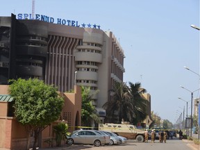 Burkina Faso troops stand guard outside the Splendid hotel and the nearby Cappuccino restaurant following a jihadist attack in Ouagadougou on Jan. 16, 2016.