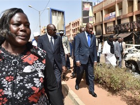 Malian Prime Minister Modibo Keita (C) and Burkina Faso's Prime Minister Paul Kaba Thieba (L) walk towards cafe-restaurant Capuccino after visiting the Splendid Hotel in Ouagadougou, following a jihadist attack by Al-Qaeda linked gunmen late on January 15, 2016.