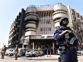 A policeman stands guard in front of the Splendid hotel, on January 17, 2016 in Ouagadougou, following a jihadist attack by Al-Qaeda linked gunmen late on January 15.   At least 29 people, including at least 12 foreigners, were killed in an Al-Qaeda attack on a top hotel in Burkina Faso, an unprecedented strike in the capital illustrating the expanding reach of regional jihadists.