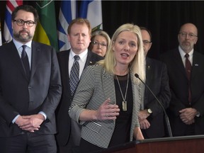 With her provincial counterparts, Minister of Environment and Climate Change Catherine McKenna speaks during a press conference Friday in Ottawa.
