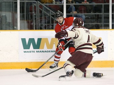 Chase Campbell #39 of the Ottawa 67's looks to make a pass against a defending Matthew Timms #4 of the Peterborough Petes.