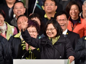 This file picture taken on January 16, 2016 shows Tsai Ing-wen (C), the president-elect of the Democratic Progressive Party (DPP), waving after her victory in the presidential election in Taipei.  China's state-run media on January 18, 2015 warned Taiwanese president-elect Tsai Ing-wen against pursuing a pro-independence path and that a formal split from the mainland would be a "dead end".