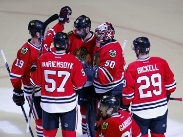 Chicago Blackhawks goalie Corey Crawford (50) celebrates his victory against the Ottawa Senators with his teammates after an NHL hockey game Sunday, Jan. 3, 2016, in Chicago. The Blackhawks won the game 3-0.