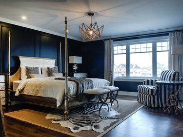 Decorator Sonya Kinkade went for drama and maximum effect with the bold black-and-white palette in Tamarack’s largest single model, the St. James. Yet it’s still warm and comfortable with a nod to a more traditional style, such as in the master bedroom panelling, which adds texture. A grand gold four-poster bed shines against the black, while adding a faux fur and animal print rug helps keep the room from becoming too serious.