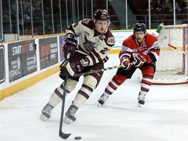 Dante Salituro #96 of the Ottawa 67's gets his stick up against a forechecking Josh Coyle #26 of the Peterborough Petes.