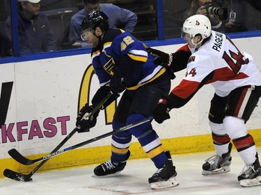 St. Louis Blues' David Backes (42) and Ottawa Senators' Jean-Gabriel Pageau (44) reach for the puck during the second period.
