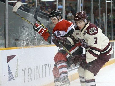 David Pearce #11 of the Ottawa 67's battles for position against Nick Grima #7 of the Peterborough Petes.