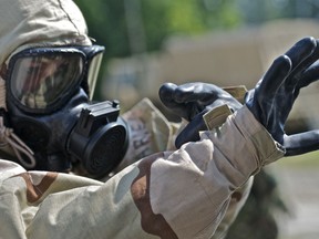 Spc. Amy Harde, a Soldier with the 108th Chemical Company, 218th Maneuver Enhancement Brigade, prepares to assist civilians through the decontamination process after a dirty bomb was detonated during a scenario during annual training. The 218th MEB is training as part of a Chemical, Biological, Radiological, Nuclear Consequense Management Response Force.