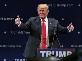 In this Jan. 7, 2016, photo, Republican presidential candidate Donald Trump flashes thumbs up after an address to a group of supporters at a campaign stop at the Flynn Center of the Performing Arts in Burlington, Vt. With three weeks to go before Iowa kicks off the 2016 presidential campaign, Trump and Sen. Ted Cruz, R-Texas, are generating overwhelming enthusiasm among Republican voters in the state.