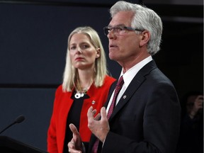 Natural Resources Minister James Carr, right, and Minister of Environment and Climate Change Catherine McKenna hold a joint news conference on pipelines on Wednesday.