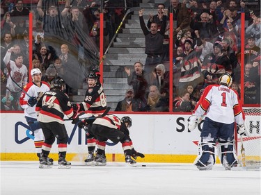 Max McCormick #89 of the Ottawa Senators celebrates his first career NHL goal against Roberto Luongo #1 of the Florida Panthers as teammate Curtis Lazar #27 picks up the puck with Jean-Gabriel Pageau #44 and Alex Petrovic #6 looking on.
