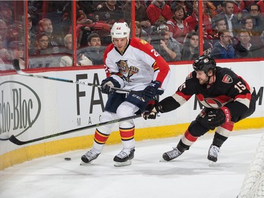 Zack Smith #15 of the Ottawa Senators challenges for the loose puck against Shawn Thornton #22 of the Florida Panthers.