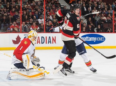 Roberto Luongo #1 of the Florida Panthers makes a save as Mark Stone #61 of the Ottawa Senators screens on the play.