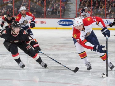 Nick Bjugstad #27 of the Florida Panthers controls the puck against Jean-Gabriel Pageau #44 of the Ottawa Senators.