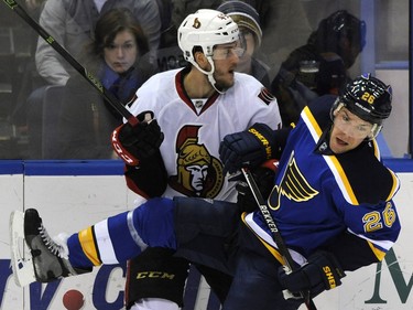 Ottawa Senators' Fredrik Claesson, left, of Sweden, collides with St. Louis Blues' Paul Stastny (26) during the first period.