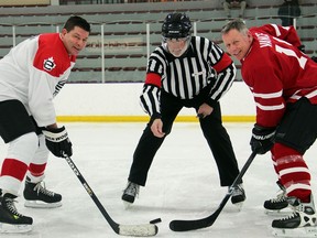 From left, Scott Taylor faces offf against Gen. Jon Vance at the Commando Challenge IV fundraising hockey game held at the University of Ottawa ice rink on Thursday, January 28, 2016.