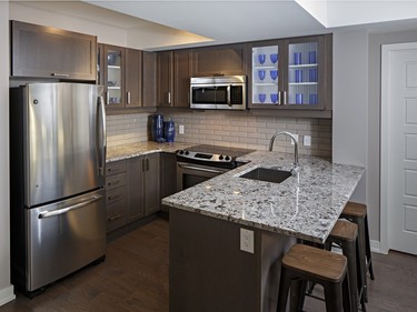 Three people can comfortably sit at the breakfast bar in the Patro, or it could be used to fold laundry just removed from the dryer located behind a pair of double doors beside the kitchen (far right).