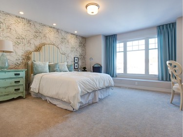 The master bedroom in the Sable showcases beautiful Van Gogh wallpaper that includes the Tiffany blue and soft green colour shown in the fabric in the room. Mix-and-match bedside tables give the look of being bought over time to make the room feel lived in rather than a show home.