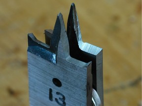 A new spade bit, foreground, with a shop-sharpened bit behind. While it’s impractical to preserve the spurs on the edges of a bit when sharpened, they¹re not necessary for clean results.