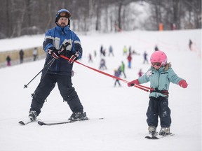 Gabrielle Gour, four, learns how to ski for the first time with her father Martin at Camp Fortune on Saturday.