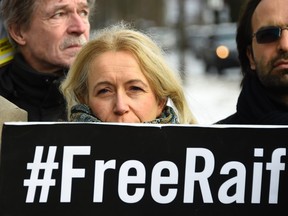 An activist of the human rights NGO Amnesty International stands behind a banner reading "#FreeRaif" as she demonstrates for the release of jailed Saudi blogger Raif Badawi in front of the embassy of Saudi Arabia in Berlin, on January 8, 2016. Badawi was sentenced to 10 years in prison and 1,000 lashes for insulting Islam.  / AFP / TOBIAS SCHWARZTOBIAS SCHWARZ/AFP/Getty Images