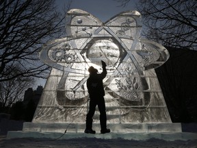 Michal Mizula from Poland works on an ice sculpture at Confederation Park in preparation for Winterlude.