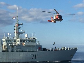 A helicopter rescue crew from Air Station Cape Cod in Bourne, Mass., trained with the Canadian navy Aug. 24, 2015, in Cape Cod Bay. An aviation survival technician and a public affairs specialist were lowered onto the Canadian Warship HMCS Summerside for a mock medical evacuation. Petty Officer 2nd Class Mario Estevane entered the ship where the "patient" was strapped to a gurney. Estevane explained in a real-word medevac he would do his own assessment of the patient and there would be a Coast Guard corpsman onboard for medical support once the patient was aboard the helicopter. Estevane explained ways to secure a patient and various hoisting techniques employed to get people off of a ship and into our aircraft. The MH-60 crew piloted the helicopter over the Summerside and lowered a basket. The Canadian crew watched as Estevane loaded the Coast Guard photographer inside the basket who was hoisted into the helicopter. After a quick presentation of Summerside hats and a plaque from the warship by the Captain, E