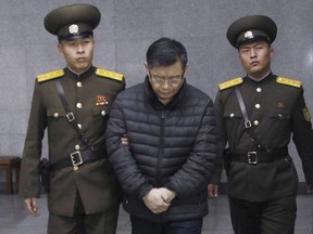 Hyeon Soo Lim, center, who pastors the Light Korean Presbyterian Church in Toronto, is escorted to his sentencing in Pyongyang, North Korea, Wednesday, Dec. 16, 2015. A Canadian pastor serving a life sentence in North Korea says he spends eight hours a day, six days a week, toiling in a labour camp, with no contact with the outside world.