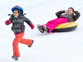 Mother and daughter at play at the Bruce Pit sledding hill.