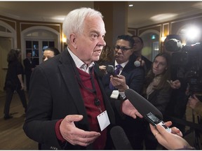Immigration Minister John McCallum talks with reporters.