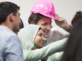 Prime Minister Justin Trudeau poses for a photo with Naadiya Moosajee, CEO of SAWomEng, a group that is developing the next generation of female engineering leaders in Africa, in Davos, Switzerland on Thursday, Jan. 21, 2016.