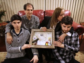 From left, Russell, Hassan, Magida and Rowdan Noureddine display some mementoes of Zack, their son and brother who died after being attacked and robbed in Toronto.