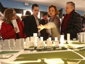 Marina and Dmitry Belik talk with Philip Elanger at the Canadian War Museum in Ottawa Wednesday Jan 27, 2016.The general public got a chance to attend the public viewing of the LeBreton Flats development proposals at the Museum Wednesday.