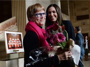 Lee Carter, left, reacts with Grace Pastine, litigation director of the BC Civil Liberties Association, inside The Supreme Court of Canada on Feb. 6, 2015. Carter and her husband accompanied her 89-year-old mother Kathleen (Kay) Carter, who suffered from spinal stenosis, to Switzerland in 2010, to end her life. The Supreme Court unanimously struck down the ban on providing a doctor-assisted death to mentally competent but suffering and "irremediable" patients.