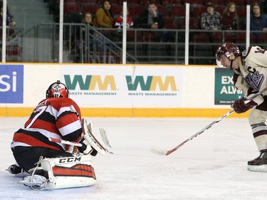 Leo Lazarev #37 of the Ottawa 67's makes a glove save against Eric Cornel #10 of the Peterborough Petes.