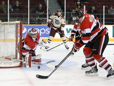 Leo Lazarev #37 of the Ottawa 67's makes a save as team mate Jacob Middleton #21 clears the puck during an OHL game against the Peterborough Petes.