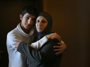 Sufian Jawabrih and his mom Najat stand in the hallway of the Radisson hotel, where 200 Syrian refugees are staying temporarily until they can move into a permanent home.