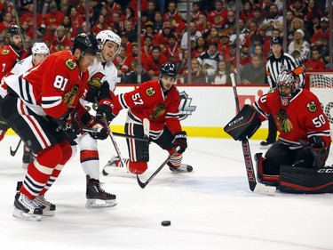 The Blackhawks' Marian Hossa attempts to hold off the Ottawa Senators' Mike Hoffman in front of the Chicago net during the first period on Sunday, Jan. 3, 2016.