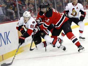 Ottawa Senators left wing Max McCormick (89) competes for the puck with New Jersey Devils defenseman John Moore (2) during the first period.