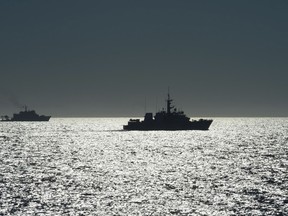 The silhouette of Her Majesty's Canadian Ship (HMCS) BRANDON (right) is seen with Mexican Naval Ship CENTENARIO DE LA REVOLUCION (left) in the distance during NAMSI PASSEX, Eastern Pacific Coast, Mexico, on October 24, 2015 during Operation CARIBBE. Photo: OP Caribbe, DND