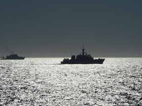 The silhouette of Her Majesty's Canadian Ship (HMCS) BRANDON (right) is seen with Mexican Naval Ship CENTENARIO DE LA REVOLUCION (left) in the distance in this 2015 photo taken during an Operation CARIBBE deployment. Photo courtesy DND.