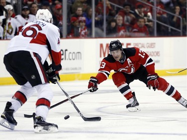 New Jersey Devils left wing Mike Cammalleri (13) competes for the puck with Ottawa Senators defenseman Patrick Wiercioch (46) during the second period.