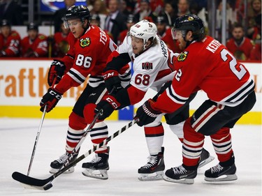Ottawa Senators left wing Mike Hoffman (68) fights for the puck with Chicago Blackhawks left wing Teuvo Teravainen (86) and defenseman Duncan Keith (2) during the first period of an NHL hockey game, Sunday, Jan. 3, 2016, in Chicago.