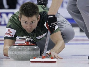 Skip Mike McEwen throws in draw 14 against Kevin Koe at the 2013 Roar Of The Rings championship in Winnipeg on December 6, 2013.