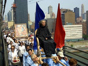The artist Kiki Smith rides a procession to MOMA's temporary home in Queens, New York in 2002.   (Chester Higgins Jr./The New York Times)