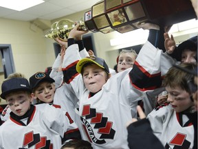 The Nepean Raiders celebrate after winning the minor atom AAA division at the 17th annual Bell Capital Cup.