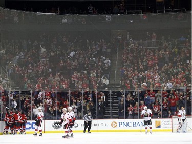 New Jersey Devils players, left, celebrate Joseph Blandisi's first career goal during the first period.